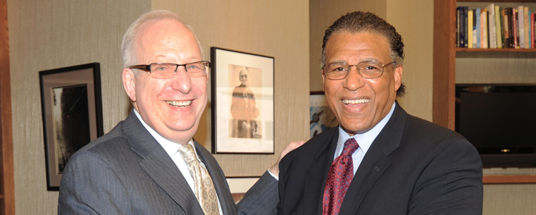 Kent State University President Lester A. Lefton (left) shakes hands with André Thornton (right), who was named the university's first President's Ambassador.