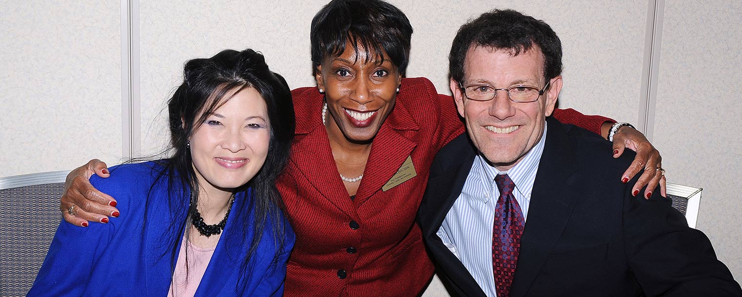 Sheryl WuDunn and Nicholas Kristof pose for a photo with Alfreda Brown (center), Kent State's vice president for diversity, equity and inclusion, during a reception in the Kent Student Center.