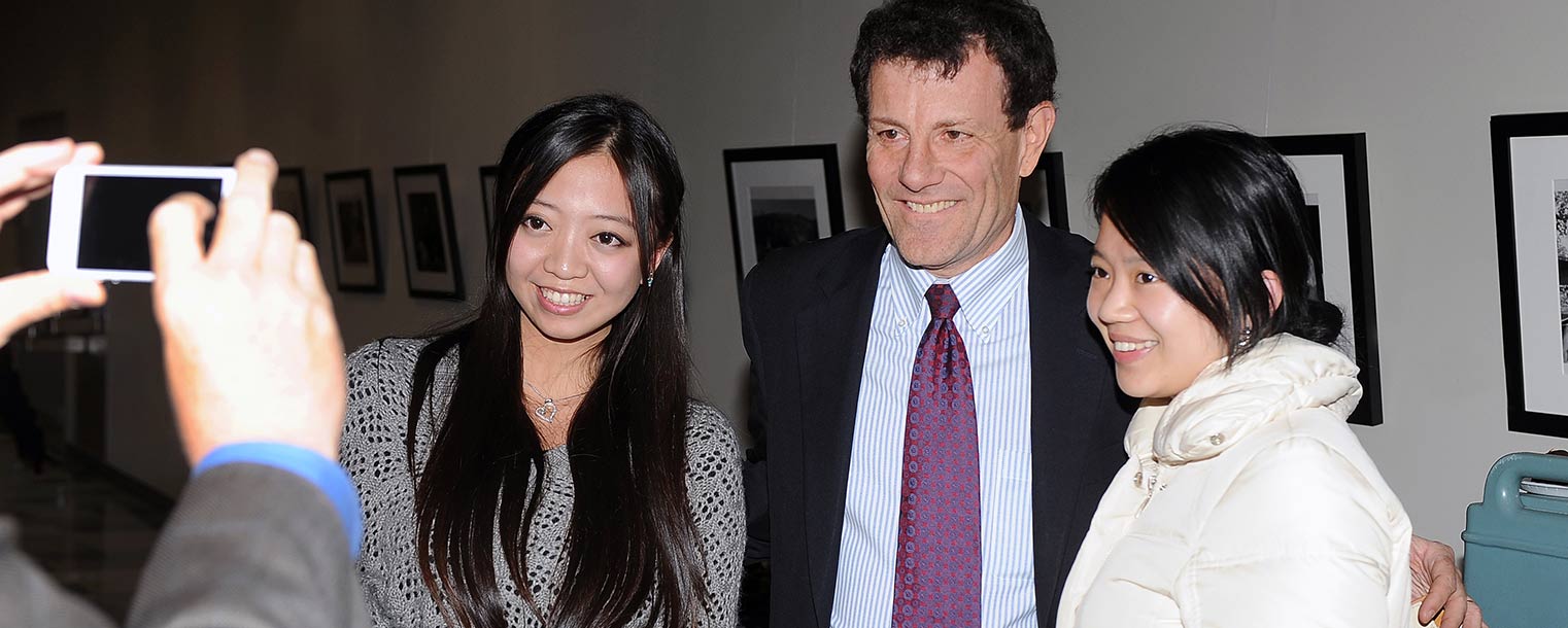 Pulitzer Prize-winning journalist Nicholas Kristof poses for a photo with Kent State students in Franklin Hall.