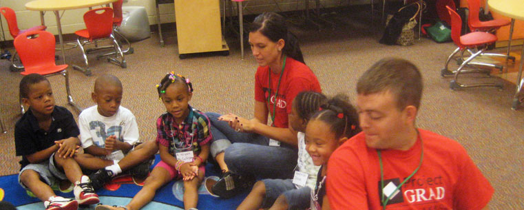 Kent State University student Andrew Flounders (early childhood education) and an University of Akron social work intern lead a fun activity with kindergarten children in the Bridges to Kindergarten program. (Photo courtesy of Janice Kroeger, Kent State University.)<br />