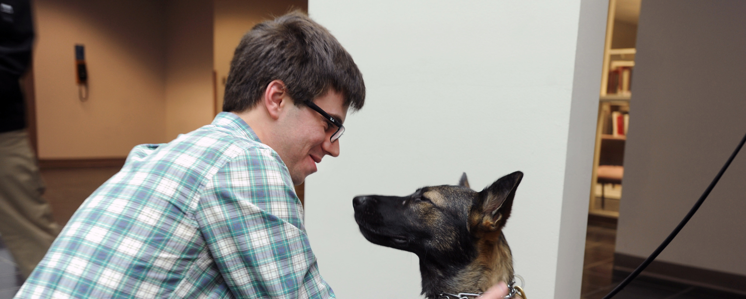 Kent State police dog Coco greets a staff member from the College of the Arts on the first floor of Rockwell Hall.