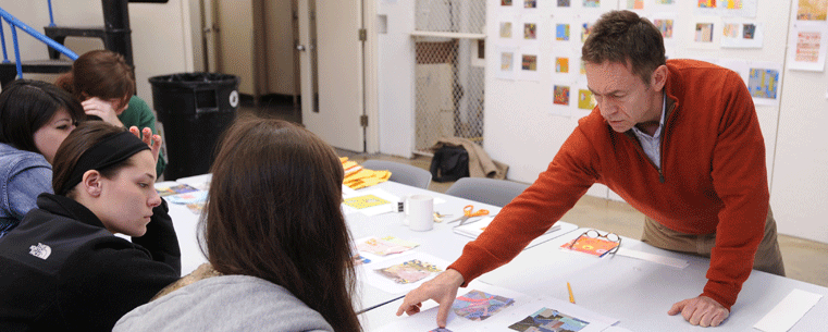 Doug Goldsmith, an assistant professor in Kent State University’s School of Visual Communication Design, critiques student work during a class in the Art Building. Kent State has been named one of the 2011 “Great Colleges to Work For.”