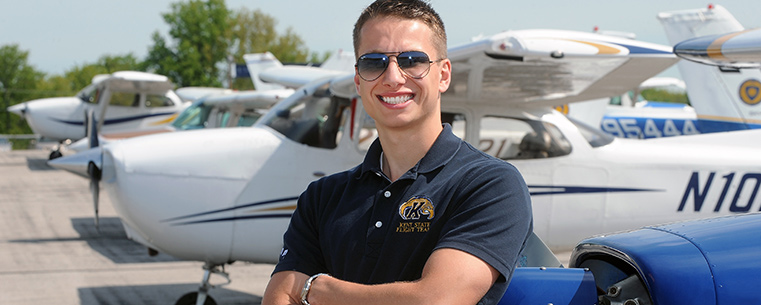 Kent State aeronautics student Ryan Weber works in and around the fleet of Kent State planes at the Andrew Paton Field in Stow, Ohio.