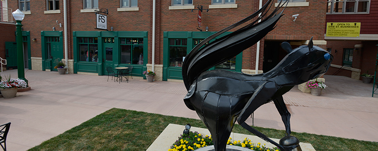 Acorn Plaza, a new venue for live music and other outdoor events at Acorn Alley II, features a black squirrel sculpture. Acorn Alley and its second phase, Acorn Alley II, are home to retail and office spaces created by Kent business leader Ron Burbick.