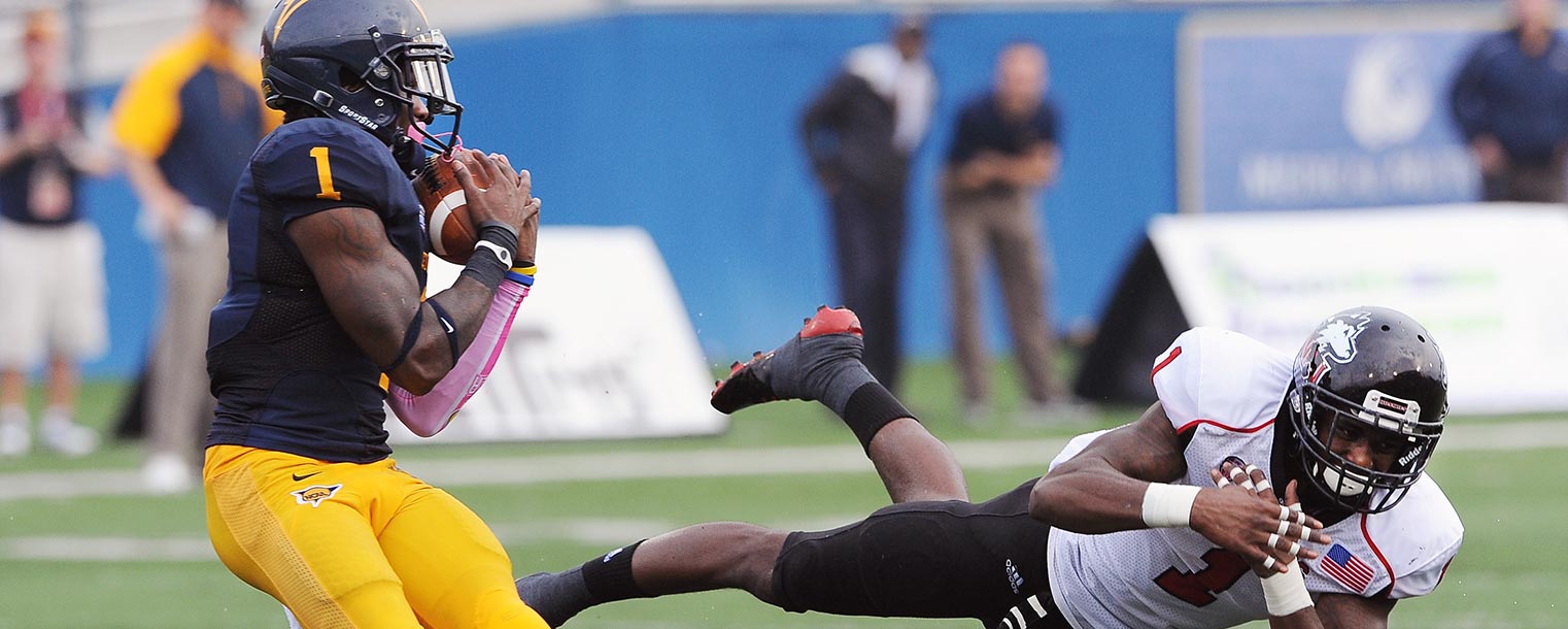 Kent State wide receiver Dri Archer comes up with a touchdown pass after a Northern Illinois defender overcommitted on a potential interception during the Homecoming game at Dix Stadium.