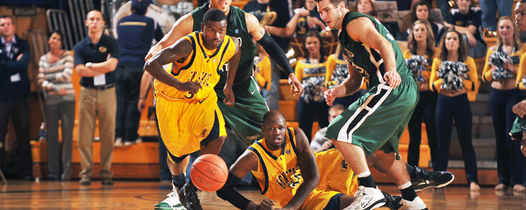 The Golden Flashes scramble for a loose ball while playing tough defense against an opponent in the Memorial Athletic and Convocation Center.