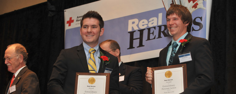 Kent State alumnus Jared Atkins and friend Paul Marschik pose with their Real Hero Awards during a presentation at the Bertram Inn in Aurora. Atkins and Marchick pulled a retired Kent State professor from her burning home.