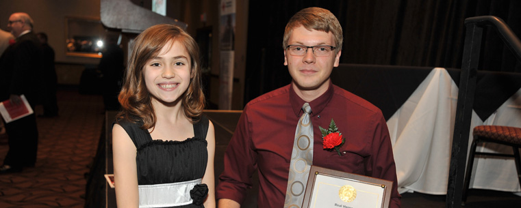 Kent State student Eric Johnston poses with the girl he pulled out the Cuyahoga River in Kent. Johnston received a Real Heroes Award from the American Red Cross for saving the girl's life.