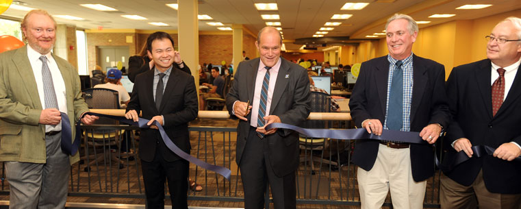 Robert G. Frank, Kent State provost and senior vice president for academic affairs, cuts the ribbon dedicating the Math Emporium on the second floor of the Kent State University Library. Among those helping is Andrew Tonge (far left), chair of the Department of Mathematical Sciences at Kent State.