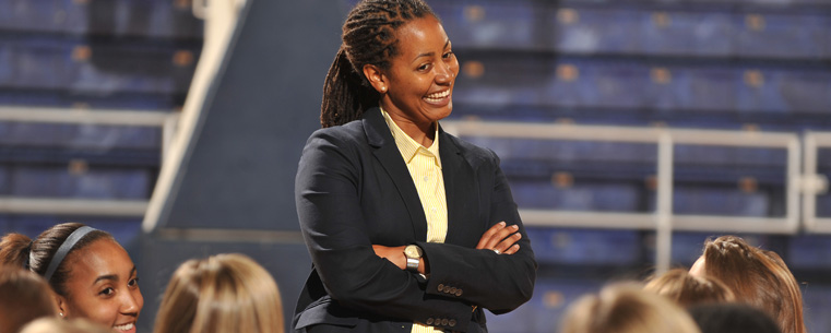 New Kent State women's basketball coach Danielle O'Banion talks with members of her team before a news conference announcing her appointment.