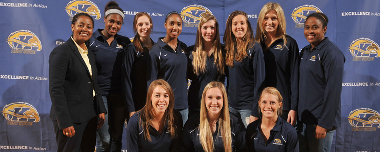 New women's basketball head coach Danielle O'Banion poses with the team following a press conference announcing her appointment.