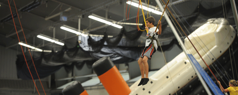 A child swings from a bungee harness during last year's Fan Experience at the Kent State Field House.