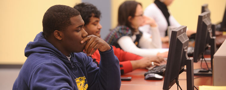 Students work on computer terminals on the first floor of the Kent State University Library.