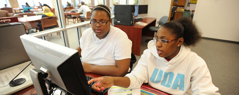 Two students work on a digital presentation in a computer lab in the Kent State University Library.