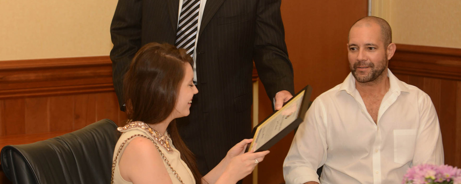 Kent State student Zoë Burch is presented with a certificate from Andrew Stefanik, regional coordination unit supervisor of Ohio Homeland Security Strategic Analysis and Information Center while her dad, Daniel Burch (right), looks on with pride.