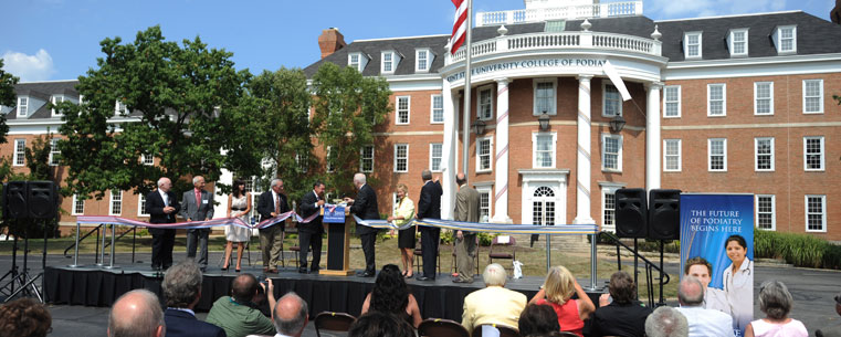 The wrapping is dropped on the official Kent State University College of Podiatric Medicine Sign during the ribbon tying event.