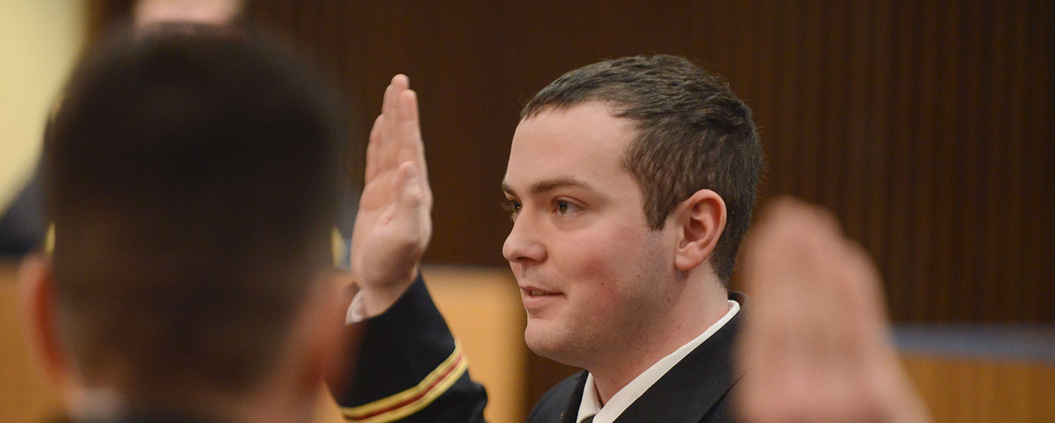 U.S. Army 2nd Lt. John Richards takes the oath of office from Lt. Col. Mark Piccone during a commissioning ceremony held in the Governance Chambers.