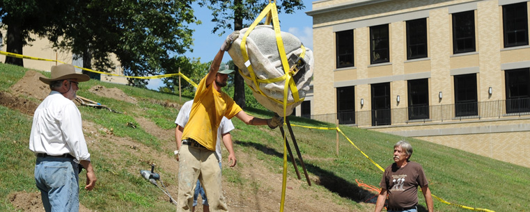 Cleveland artist Giancarlo Calicchia supervises the installation of "Athleta" near Kent Hall.