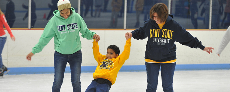 A little brother of a Kent State student gets some assistance to stay up on ice skates during Lil’ Sibs Weekend.