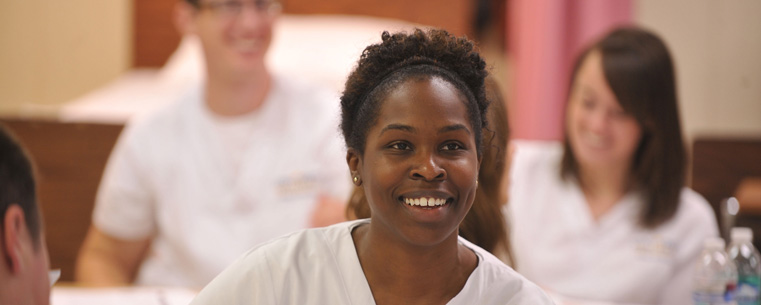 <p>A Kent State student in the accelerated nursing program listens to a class lecture.</p>