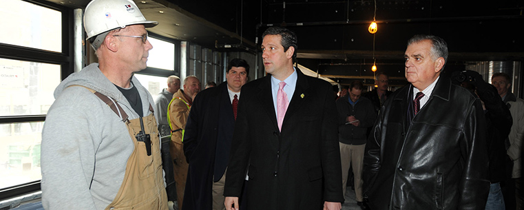 Congressman Tim Ryan and U.S. Transportation Secretary LaHood speak with a construction worker at the Kent Central Gateway multimodal transit center in downtown Kent.