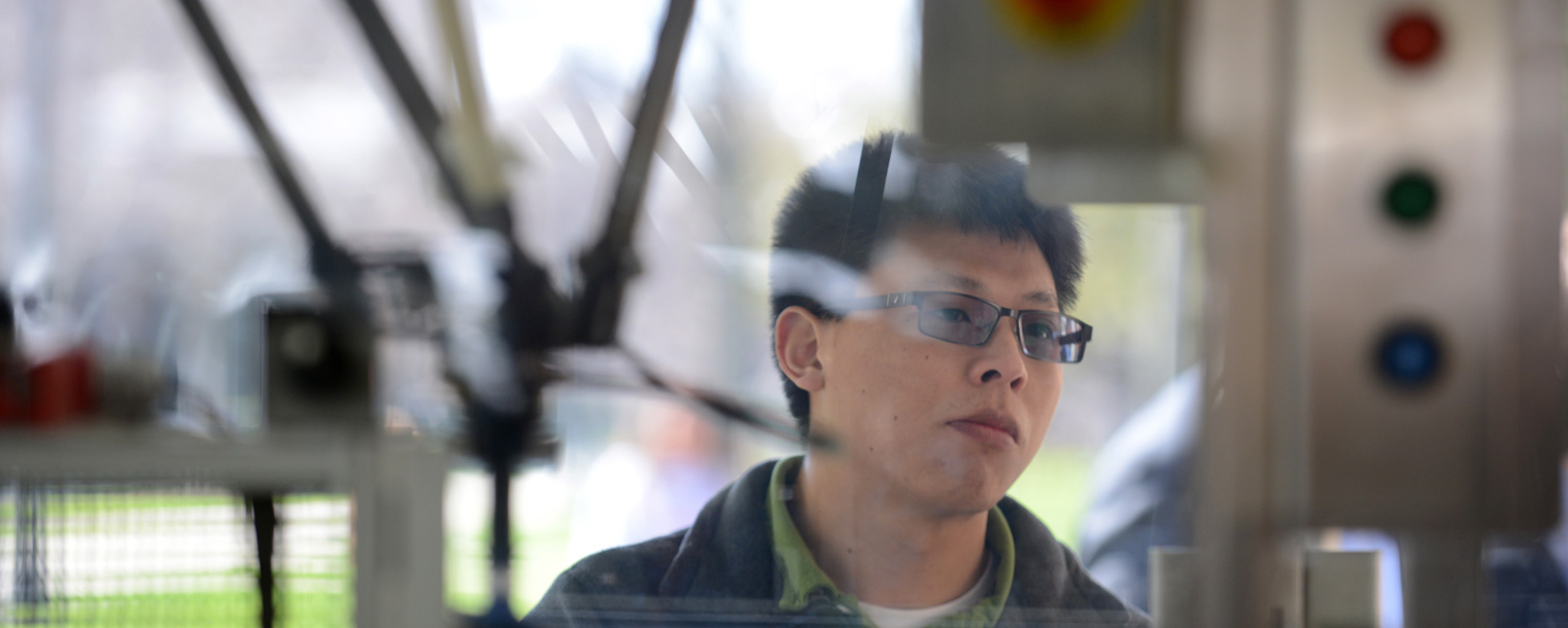 A Kent State student looks at a display put up by Rockwell Automation. The display showed the use of robots in manufacturing.