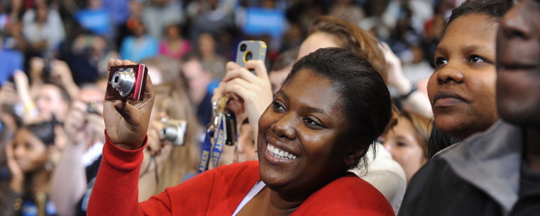 An Obama supporter takes photos of the president while he is speaking in the MAC Center.