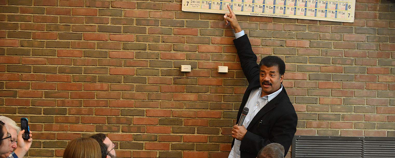 Neil deGrasse Tyson points out specific elements on the Periodic Table while speaking with Kent State students in the planetarium at Smith Hall.