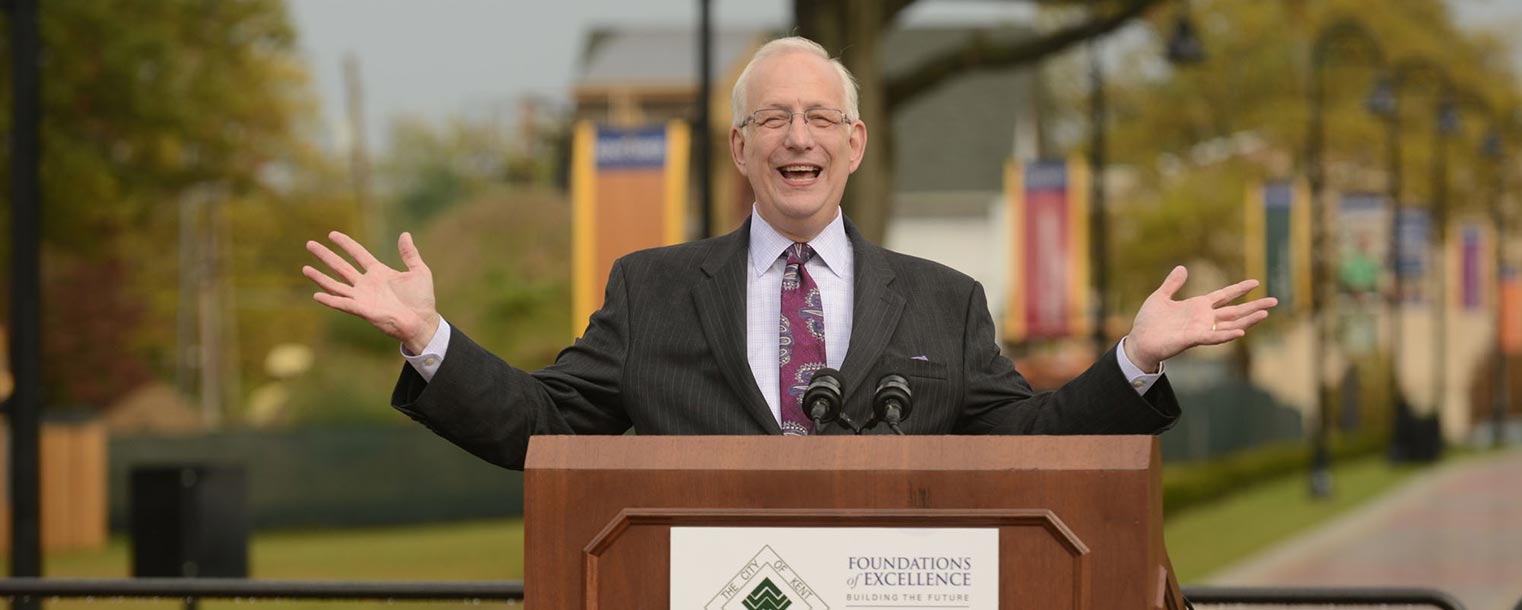 Kent State President Lester A. Lefton is all smiles as he welcomes the crowd to the celebration of the solid partnership between Kent State and the city of Kent and the official opening of the University Esplanade.