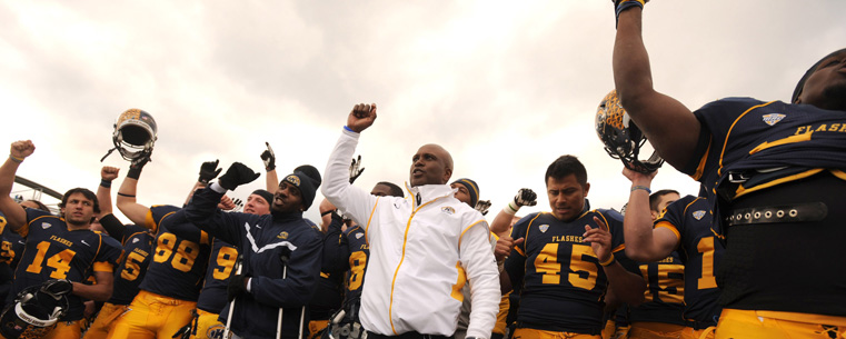 Coach Hazell and the Golden Flashes sing the KSU fight song after the football team's victory over Ohio University.