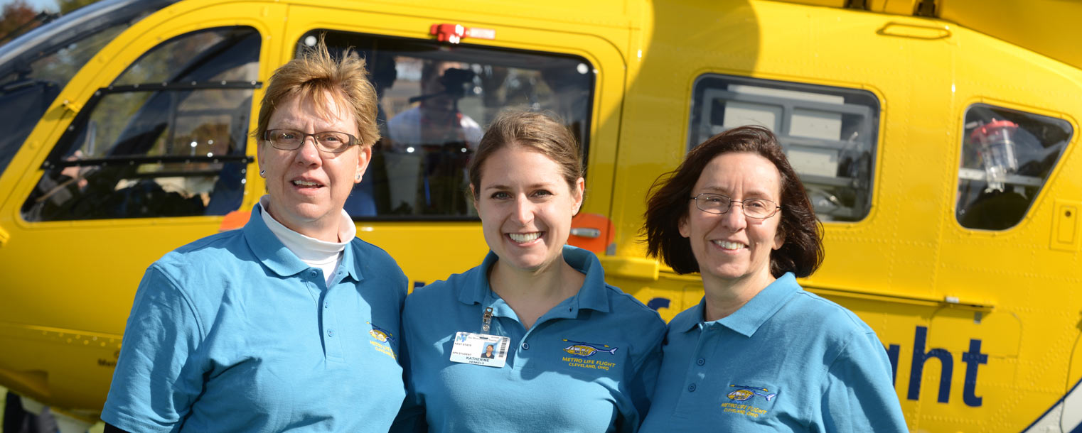 Kent State graduate nursing student Katherine Henkels (center) stands with Kent State College of Nursing faculty members Louann Bailey (left) and Ellen Prewitt (right) in front of a Metro Life Flight medical helicopter.