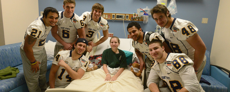 Members of the Kent State football team visit with hospital patient Amber Mozingo at the Children and Women's Hospital in Mobile, Alabama.