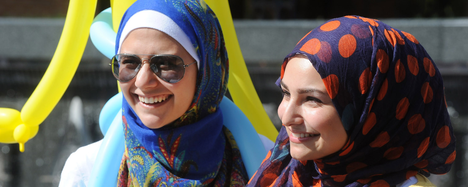 Two members of the Muslim Students Association enjoy the sunny day on Risman Plaza while participating in the 32nd Annual Black Squirrel Festival.