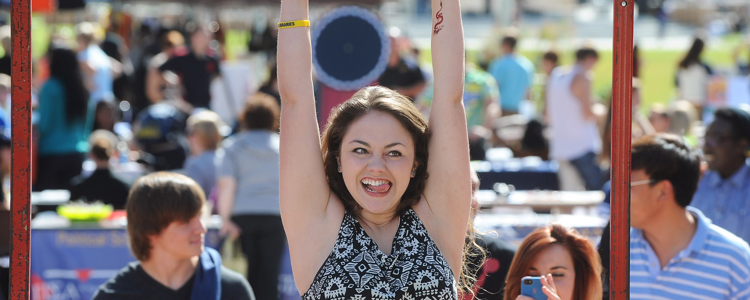 A Kent State student struggles with a pull-up while participating in an ROTC contest on Risman Plaza during the 32nd Annual Black Squirrel Festival.