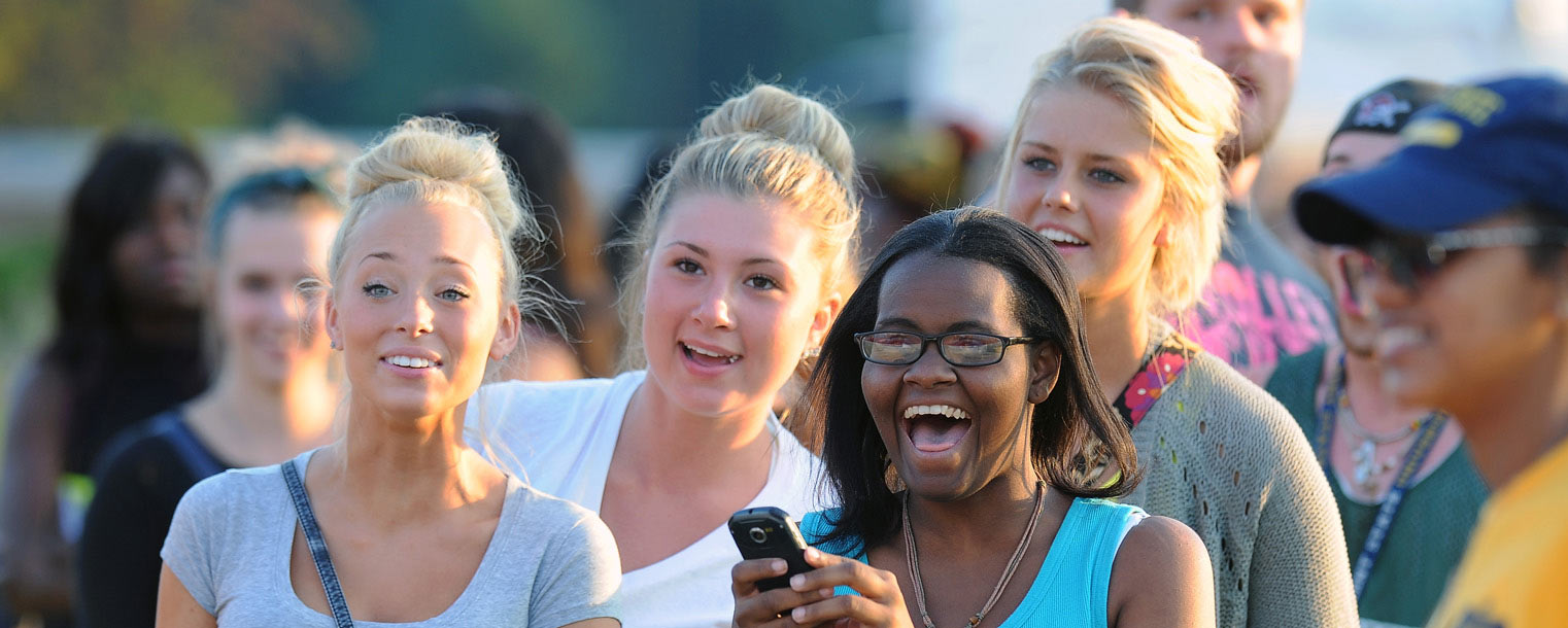 <p>Kent State students share a laugh while participating in the festivities on the Student Green during the back-to-school Blastoff.</p>