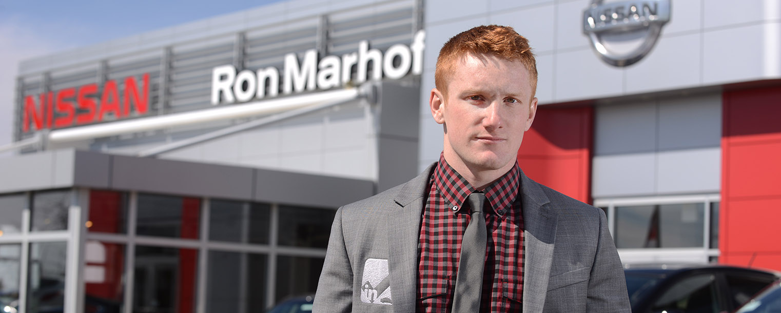 Brock Bernholtz, a junior entrepreneurship major at Kent State, stands in front of Ron Marhofer Nissan in Cuyahoga Falls, Ohio. Bernholtz created InCheck Services LLC, a drop-off tracking application that allows customers to stay in touch with items that are dropped off for repairs, changes and more.
