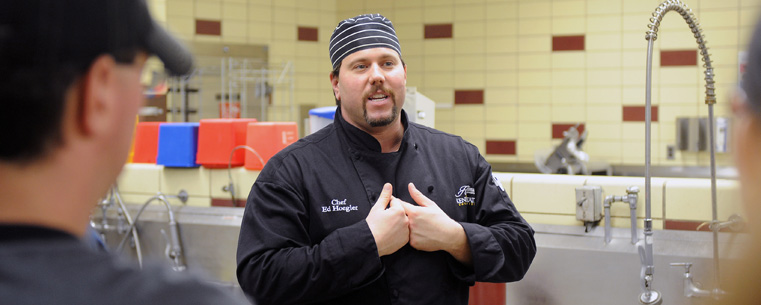 Chef Ed Hoegler from Kent State's Hospitality Management program speaks during the grand opening of the Campus Kitchen at Kent State in Beall Hall.