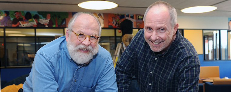 Popular comic strip artists Chuck Ayers (left)and Tom Batiuk (right) and take a break during the art installation in the new student lounge area called The Nest in the Kent Student Center. The lounge features art created by the two Kent State University alumni.