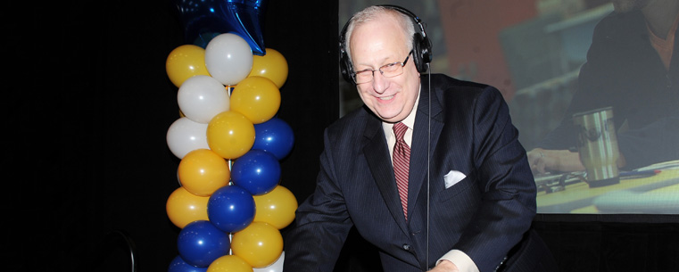 President Lester A. Lefton plays the role of DJ during the annual Flashes Forever celebration in the Fieldhouse, Friday, Dec. 12.