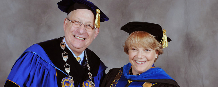 <p>President Lester A. Lefton compares university medallions with commencement speaker Virginia Horvath, following the advanced degree ceremony in the Memorial Athletic and Convocation Center.<br />
<br />
</p>