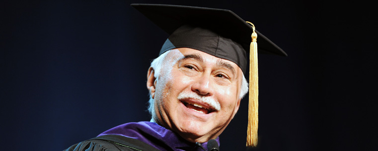 Kent State President's Ambassador Jose Feliciano addresses the audience attending the morning commencement ceremony in the Memorial Athletic and Convocation Center.