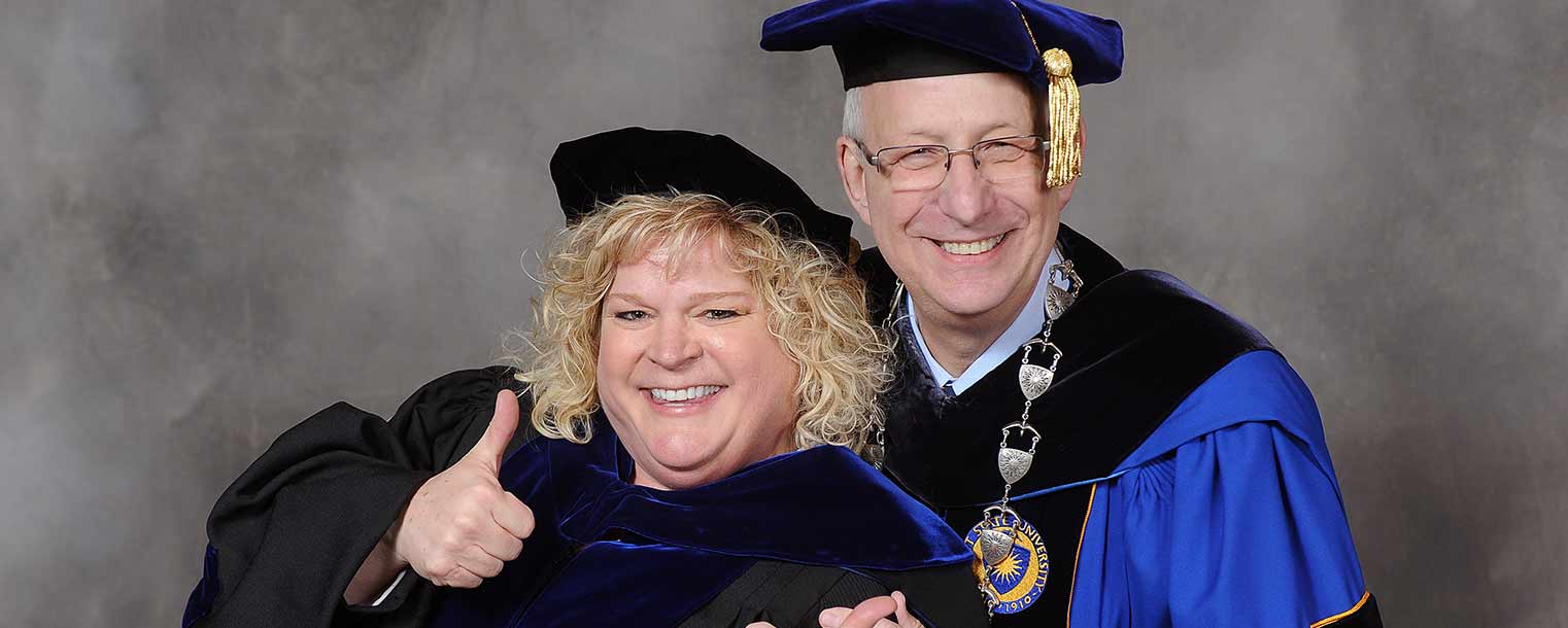 Commencement speaker Melody Tankersley celebrates with Kent State President Lester A. Lefton following the Dec. 13 evening ceremony for those receiving their master’s and doctoral degrees.