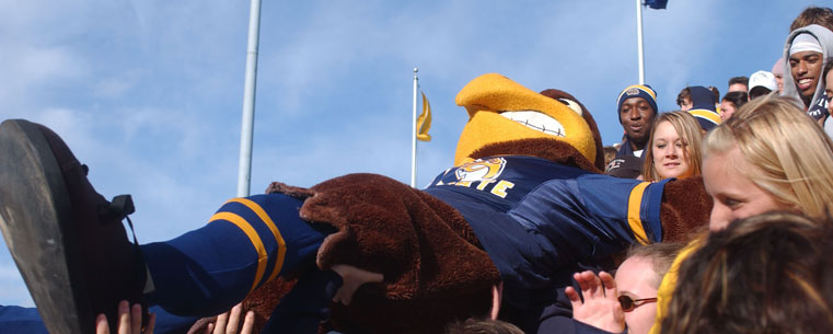 Flash "crowd surfs" in the student section during a football game at Dix Stadium.