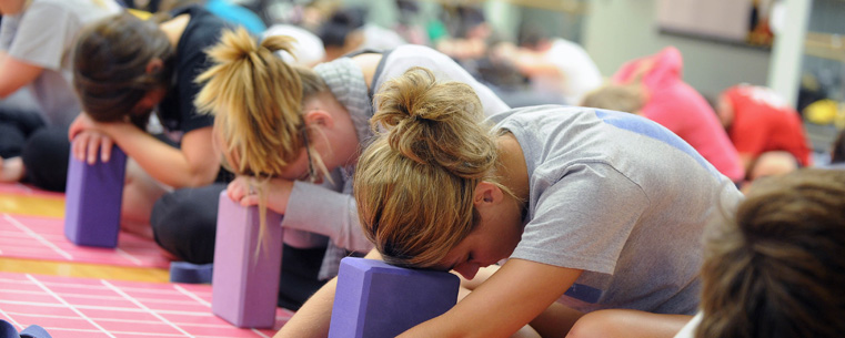 Kent State nursing students participate in a yoga session at the Student Recreation and Wellness Center as part of the nursing school's "Care for the Caregiver" program. Kent State has collaborated with fashion designer Donna Karan's Urban Zen Foundation on this program that focuses on self-care of nurses and its professional value of caring for the self in their education.