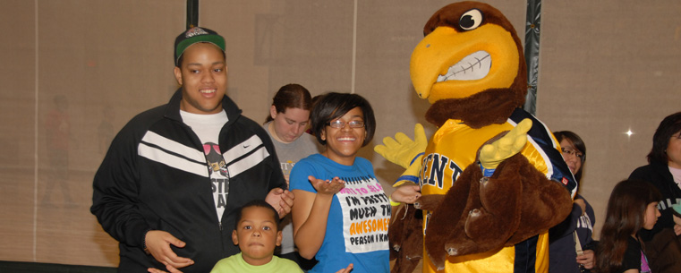 <p>Little sibs and big sibs pose with Flash, Kent State University’s mascot, at the Student Wellness and Recreation Center during last year's Lil Sibs Weekend. This year's Lil Sibs Weekend takes place April 13-15.</p>