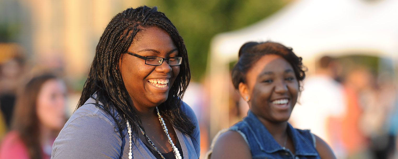 Incoming Kent State freshmen share a laugh during the back-to-school Blastoff held on the Student Green.