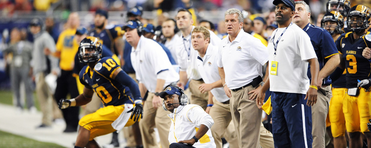 Head Coach Darrell Hazell and the team watch a field goal attempt in overtime, during the MAC Championship game at Ford Field, in Detroit.