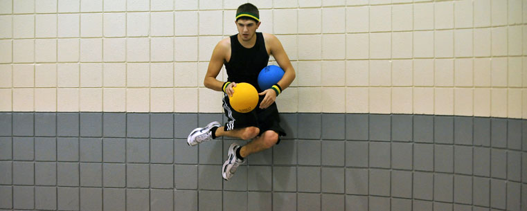 Kent State Dodgeball Club co-captain Ryan Mann goes high on a wall to avoid a throw during a match in the Student Recreation and Wellness Center.