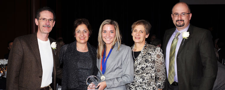 Family members of the late Kent State Professor Dr. Anthony Silvidi are honored by Founders Scholars student Emily Woods (center) during the awards ceremony.