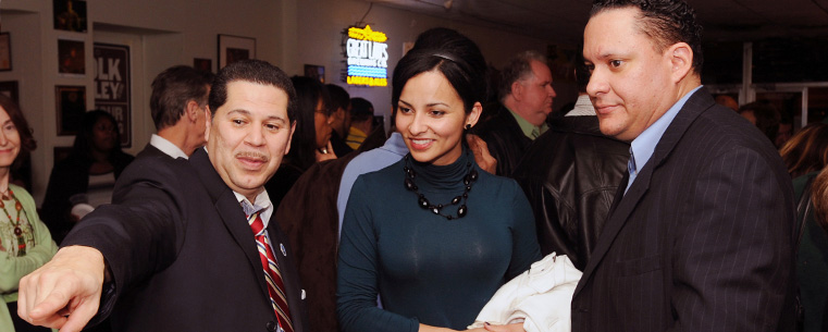 Guest admire traditional Puerto Rican artwork during the intermission of the Edwin Colon Zayas concert at the Kent State.